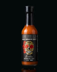 Hot sauce bottle with a black label featuring a skull design on a black background