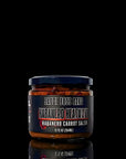 Jar of Habanero Heatwave salsa with a black label on a reflective surface.