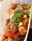 Sauce Boss Gang smoky chipotle hot sauce on a chicken taco.