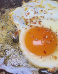 Sauce Boss Gang Volcanic Kiss seasoning on an over easy egg.