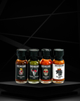 granada spanish chipotle  travel size hot sauce, toro verde jalapeno travel size hot sauce, coffin travel size habanero hot sauce and La Jefa garlic scorpion travel size hot sauce collection front view.