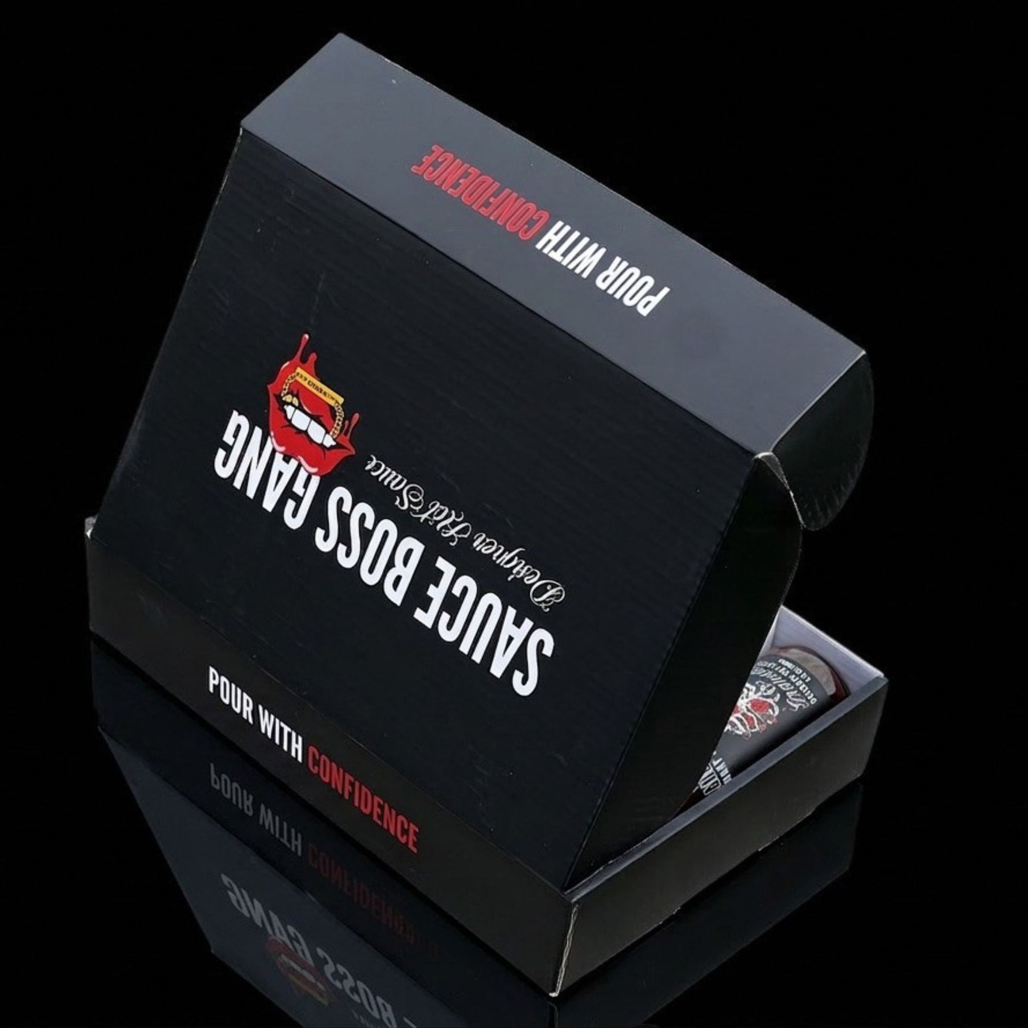 Black packaging box with 'Sauce Boss Gang' branding on a reflective black surface.