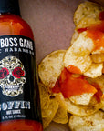 Sauce Boss Gang Garlic habanero hot sauce on potato chips.