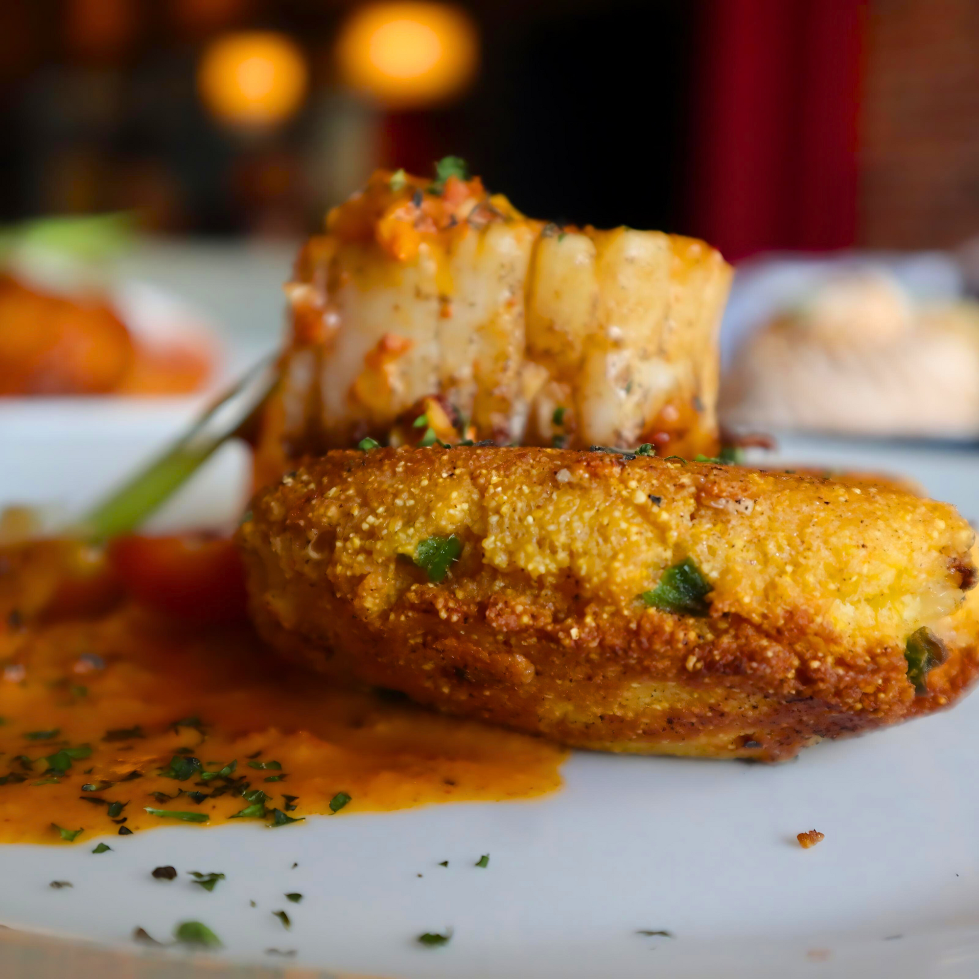 Crab cakes with Sauce Boss Gang garlic habanero hot sauce.