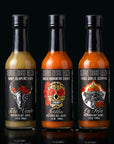 Set of six hot sauce bottles with labels on a black background