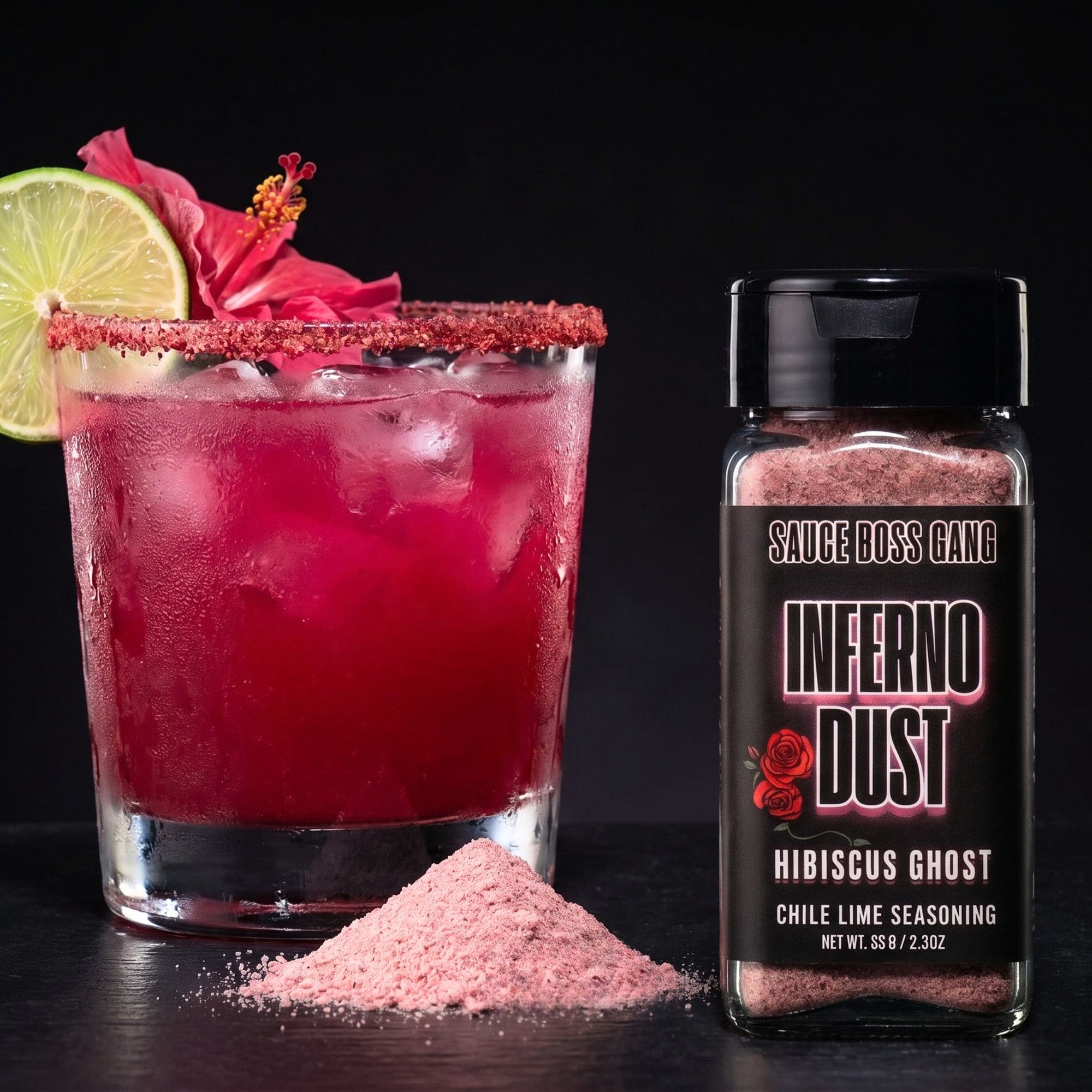 Margarita with lime and flower garnish next to a bottle of 'Inferno Dust' seasoning.