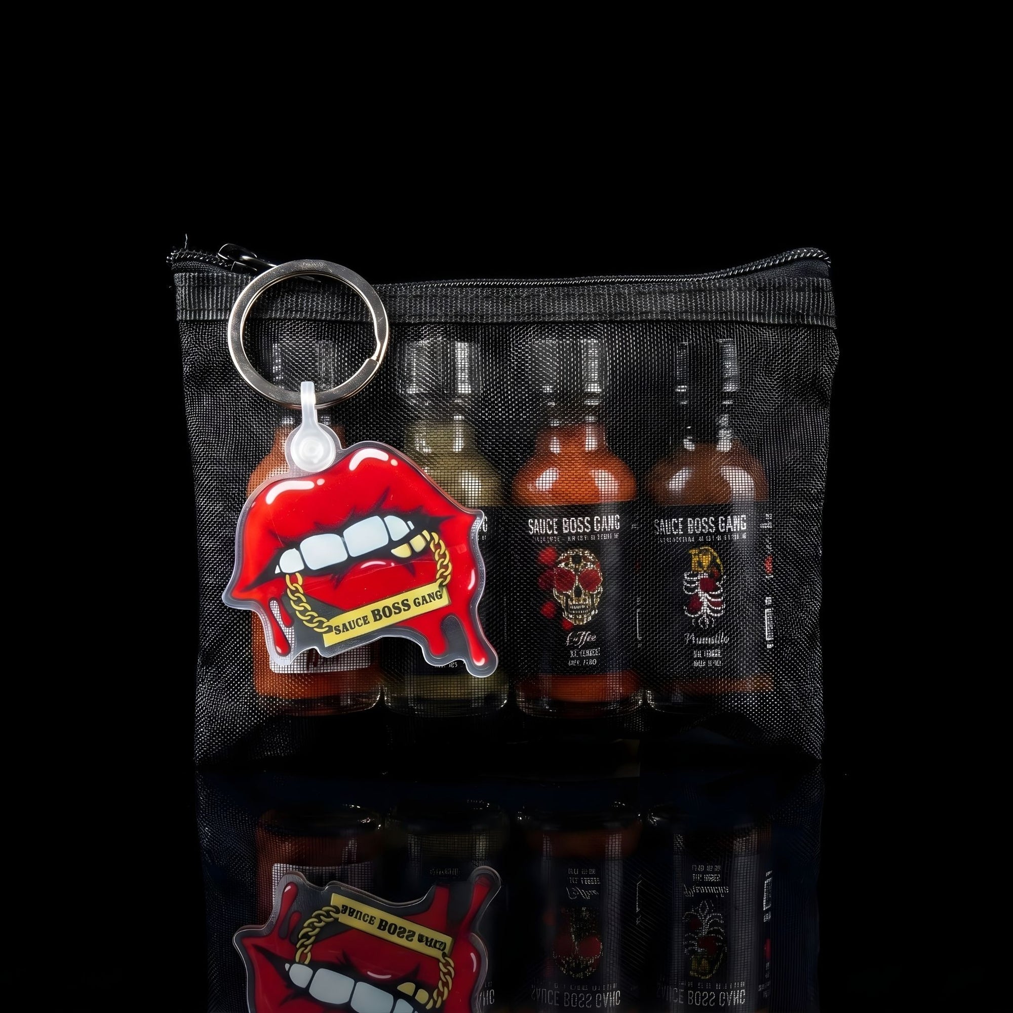 Keychain with red lips and 'Spice Boss Gang' branding on a black mesh pouch with bottles inside.