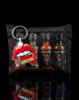 Keychain with red lips and 'Spice Boss Gang' branding on a black mesh pouch with bottles inside.