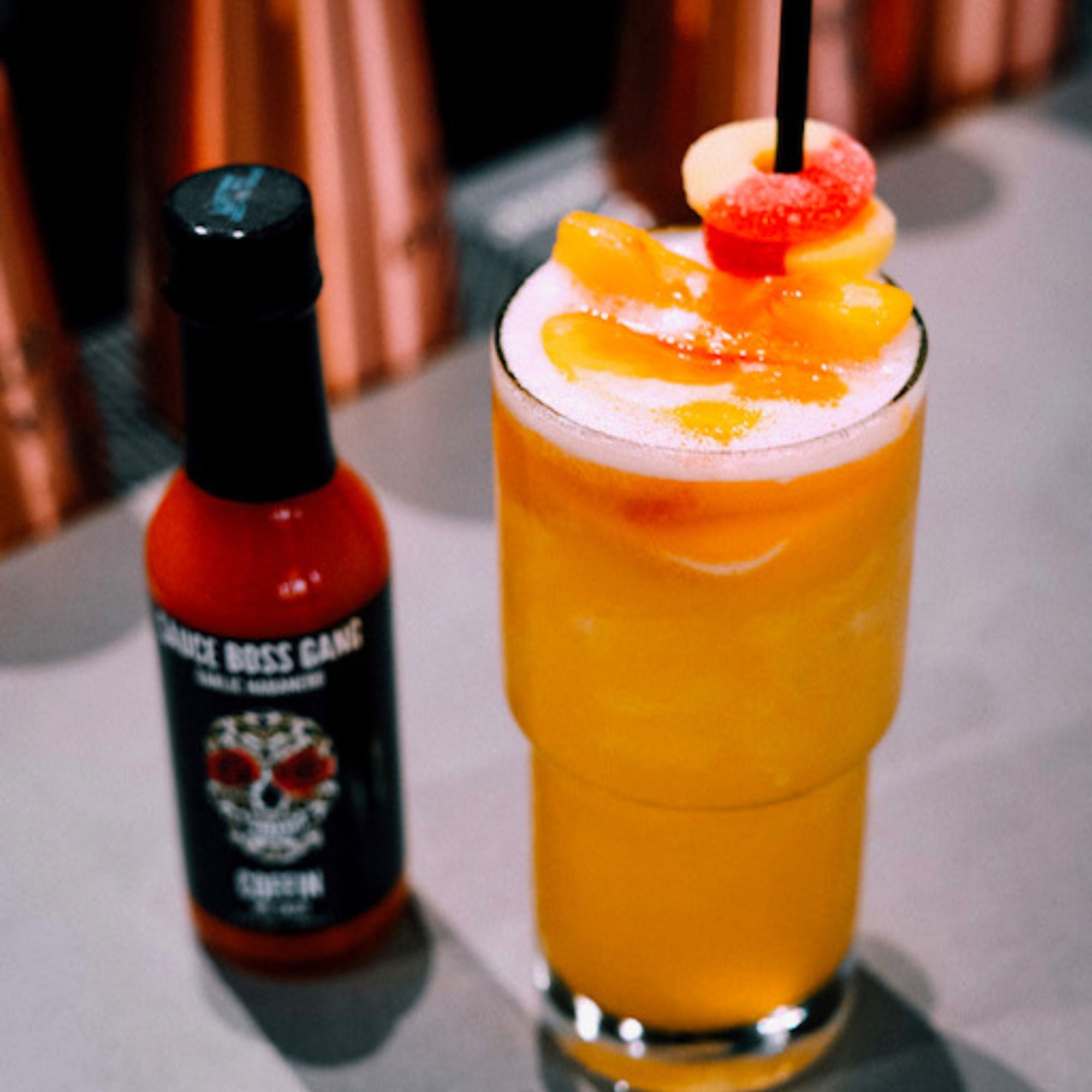 Sauce Boss Gang garlic habanero hot sauce in a cocktail.