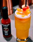 Sauce Boss Gang garlic habanero hot sauce in a cocktail.