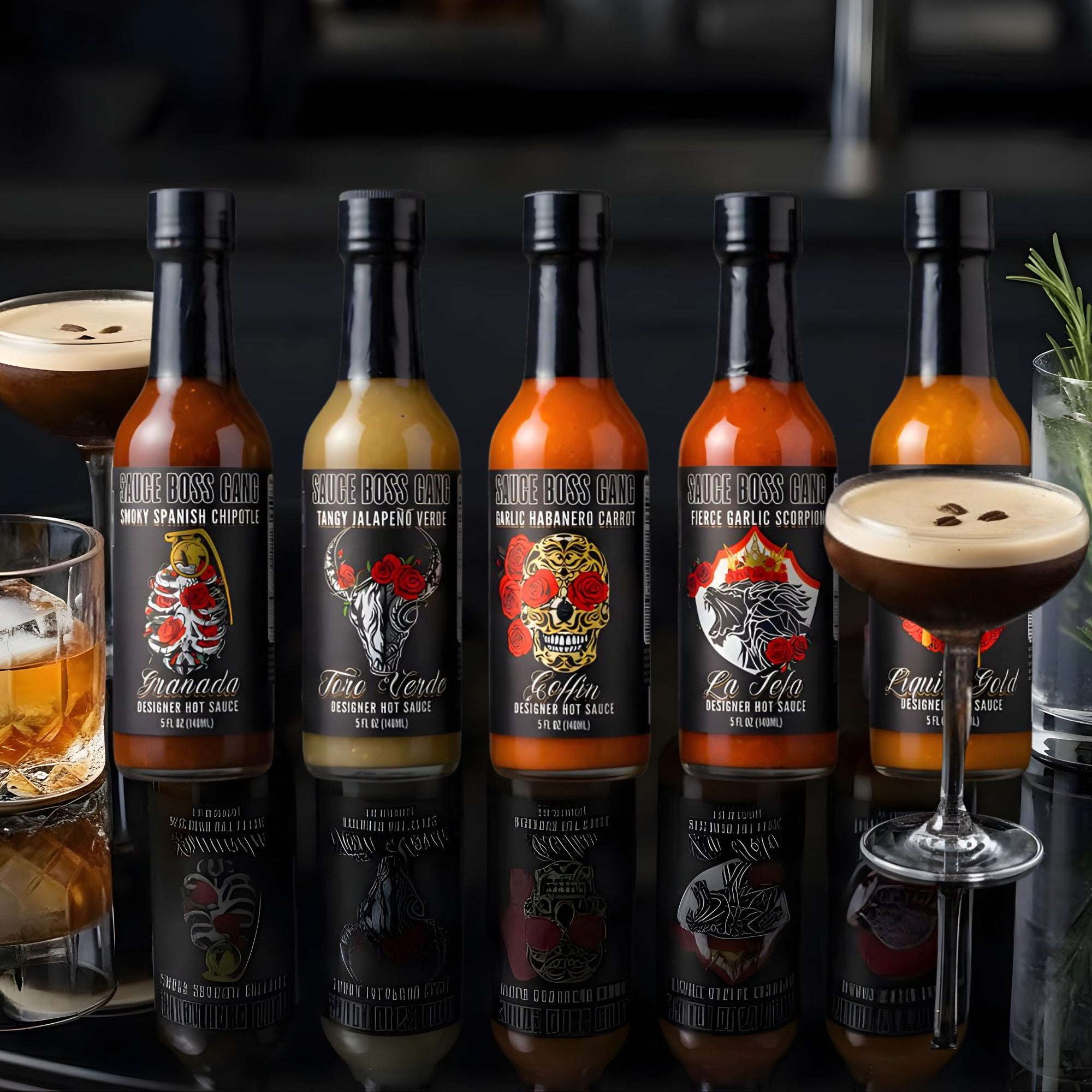 Row of hot sauce bottles with corresponding sauces in glasses on a reflective surface.