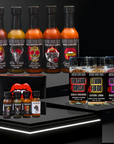 Collection of hot sauce bottles and packaging on a dark background