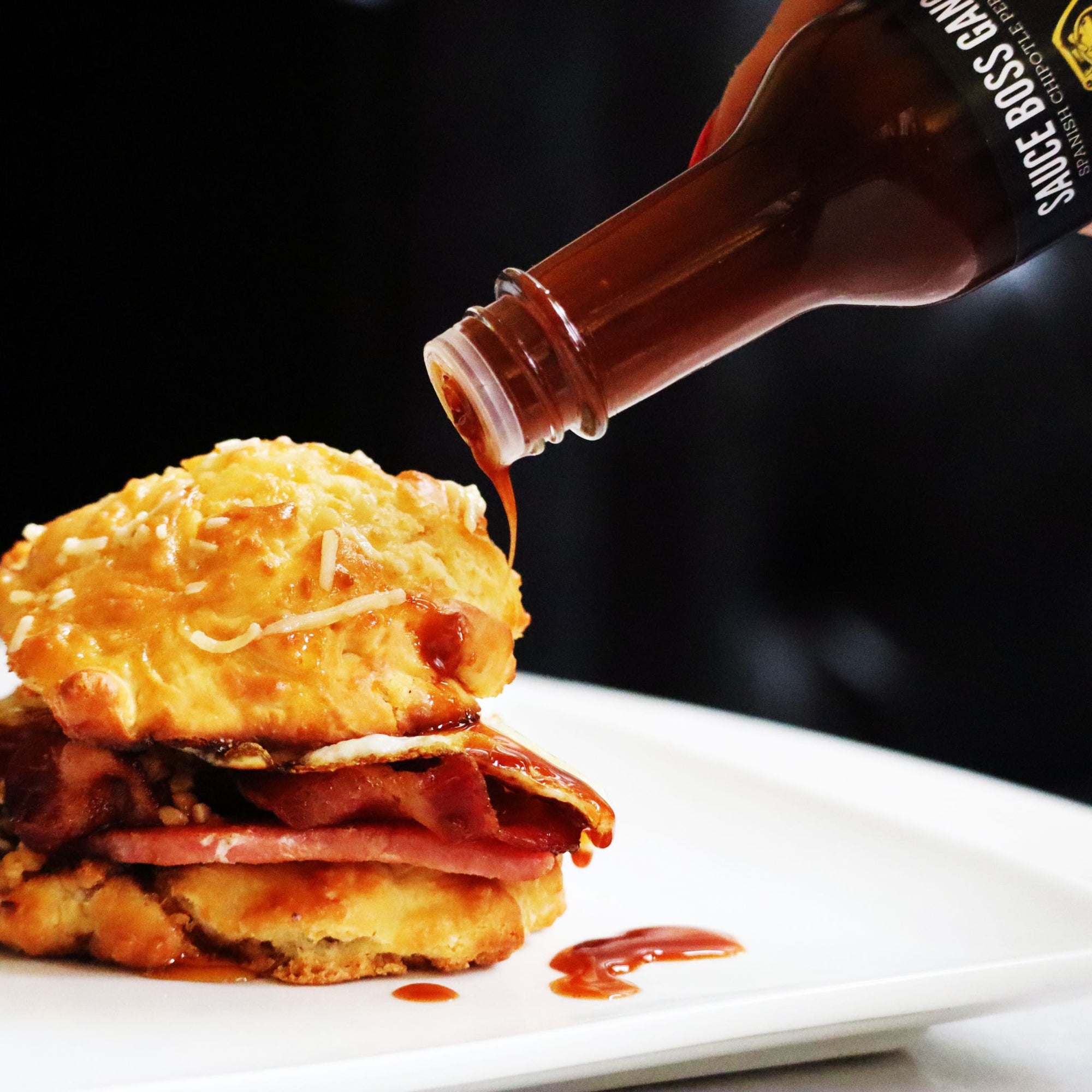 Sauce Boss Gang smoky chipotle hot sauce on a breakfast sandwich.