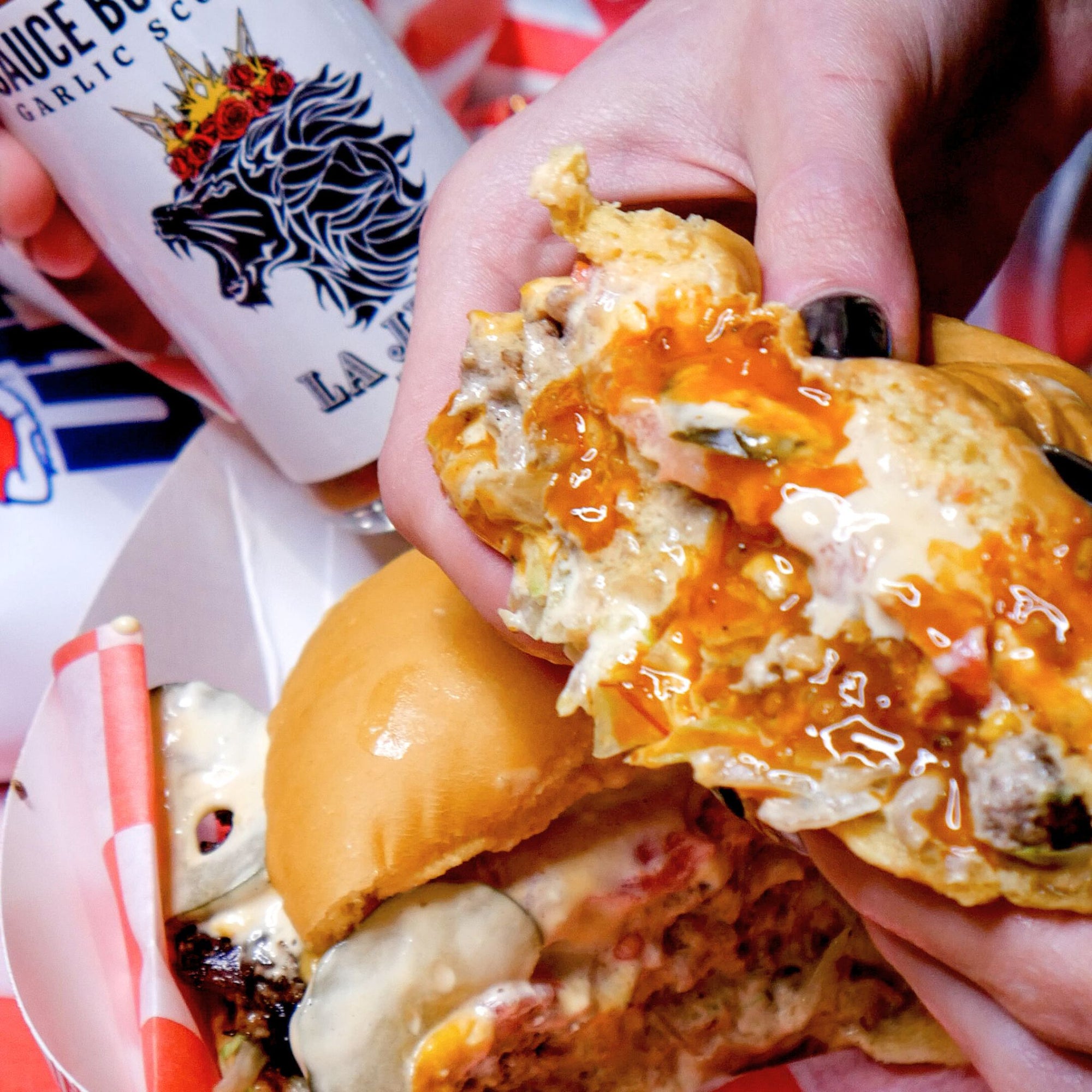 Sauce Boss Gang mustardseed scorpion pepper hot sauce on a cheeseburger.