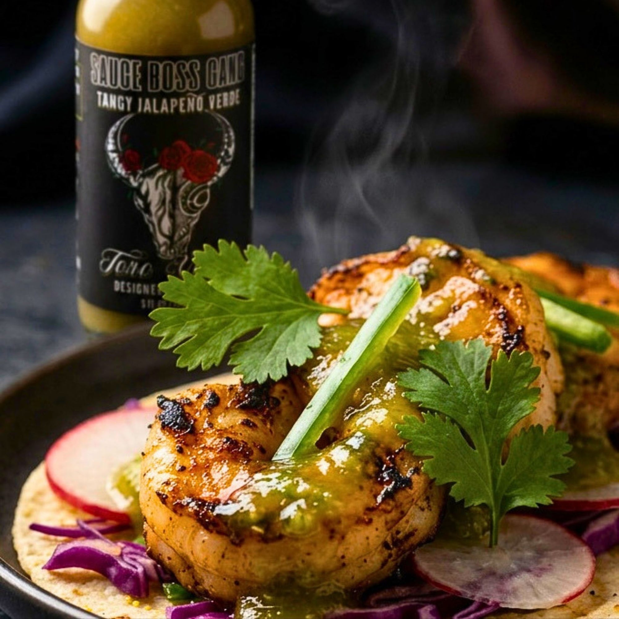Grilled shrimp taco with jalapeno sauce and a bottle of Sauce Boss Gang sauce in the background.