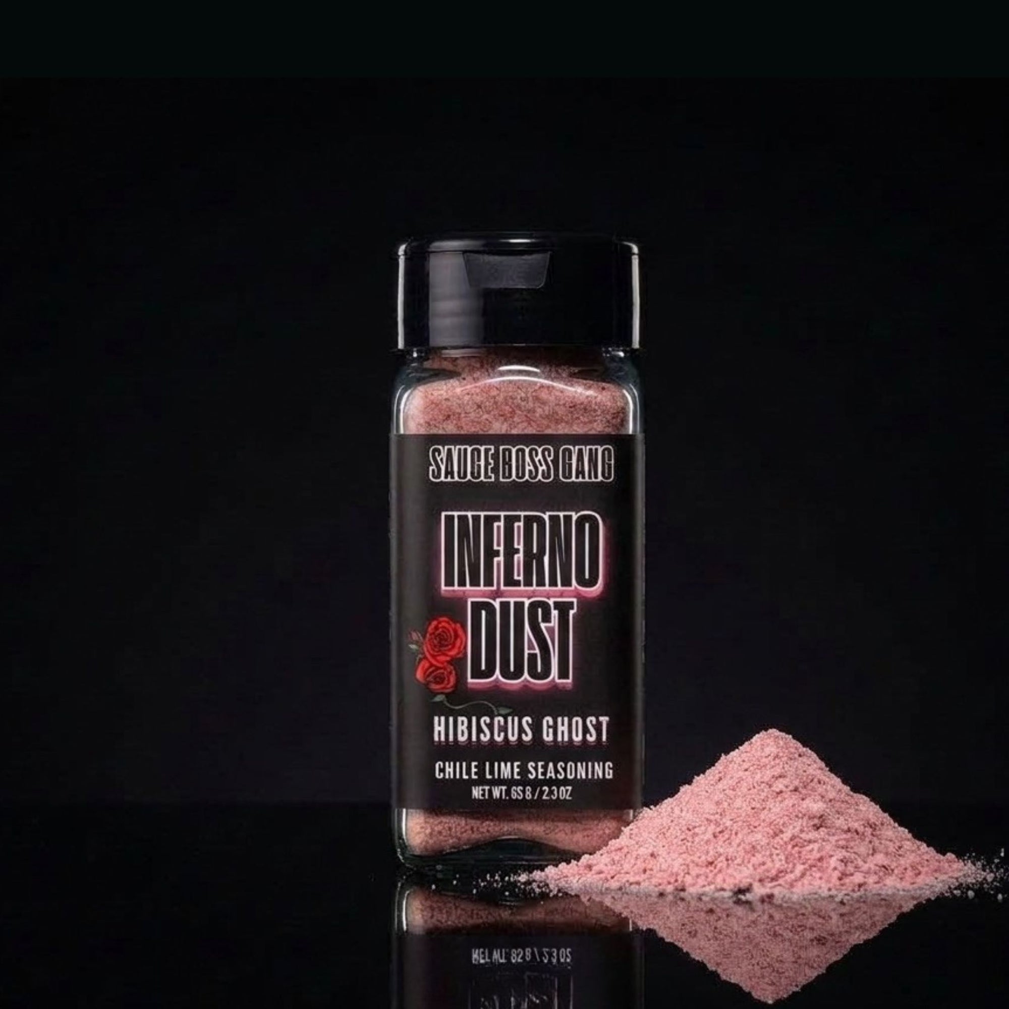 Bottle of 'Inferno Dust' seasoning with pink powder on a black background